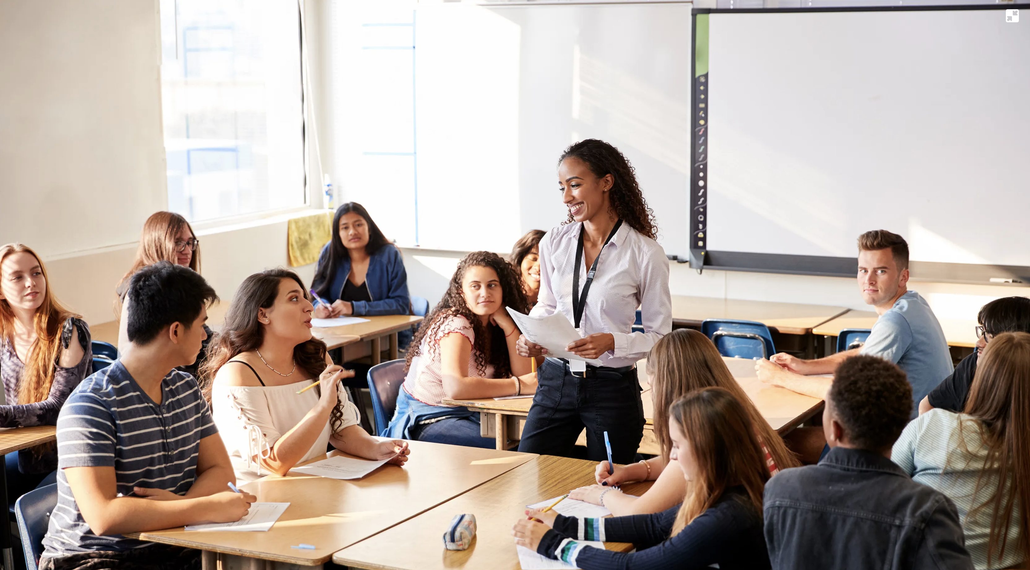 Happy teacher in classroom